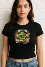 Flat lay of a women's cropped graphic T-shirt featuring the words AI Slop Inspector, styled as a casual everyday top.
